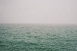 a large body of water sitting under a cloudy sky