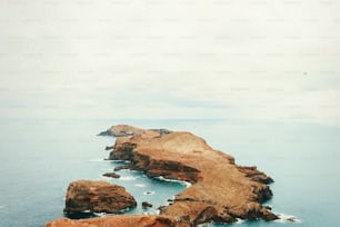 a couple of large rocks in the middle of a body of water