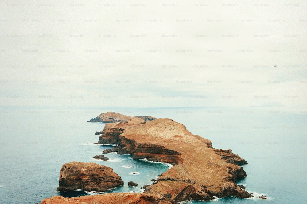 a couple of large rocks in the middle of a body of water