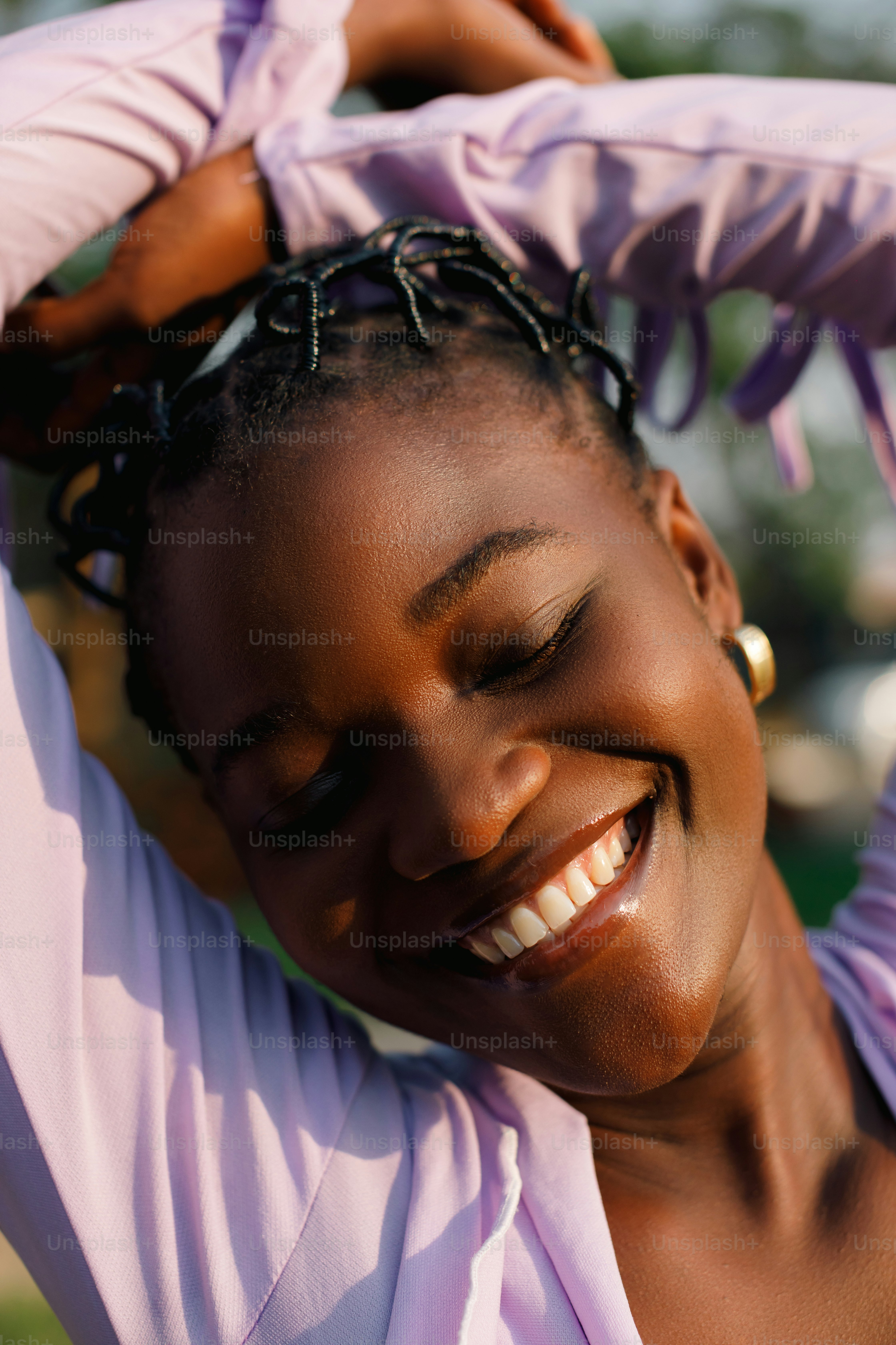 a smiling woman with her hair in a bun