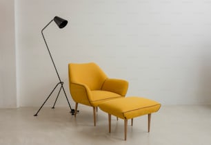 a yellow chair and a black lamp in a room