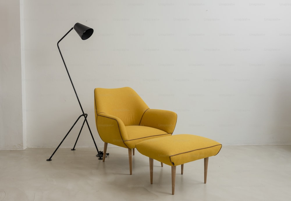 a yellow chair and a black lamp in a room