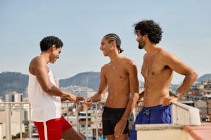 a group of three men standing next to each other