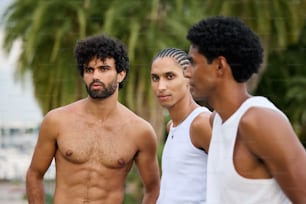 a group of three men standing next to each other