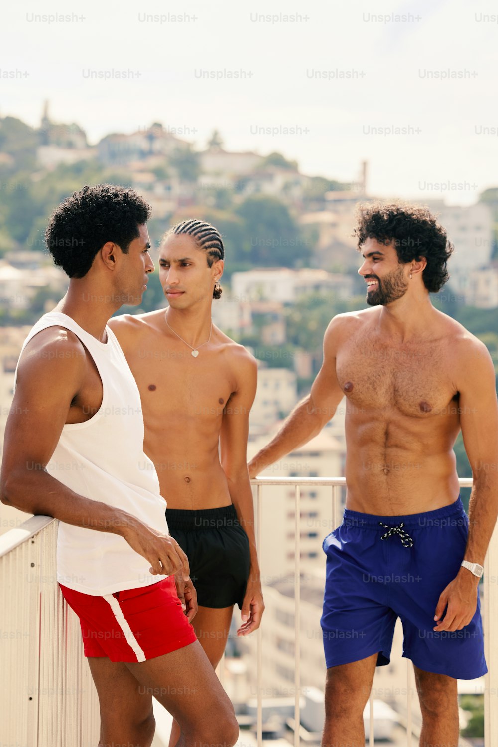 a group of three men standing next to each other