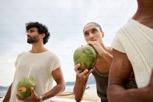 a man and a woman holding coconuts in their hands