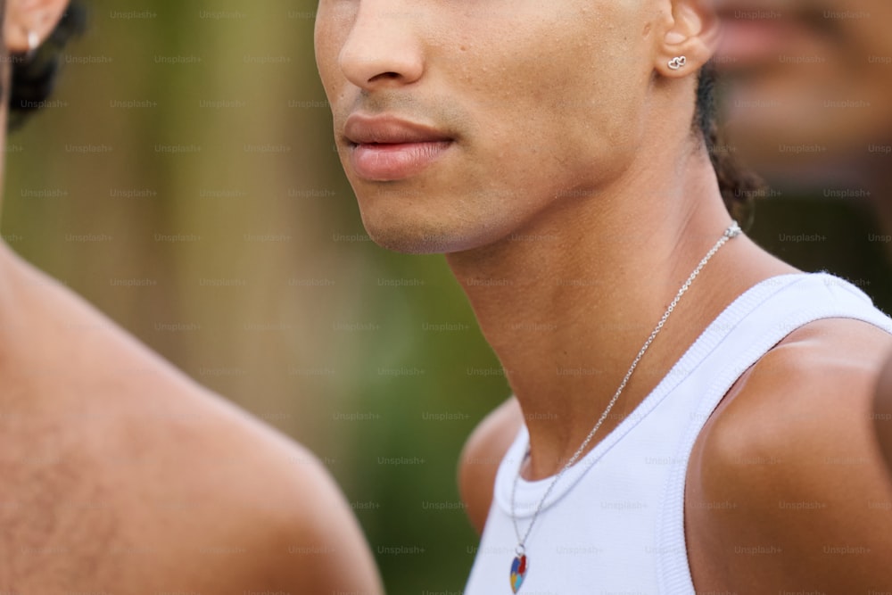 a close up of a person wearing a necklace