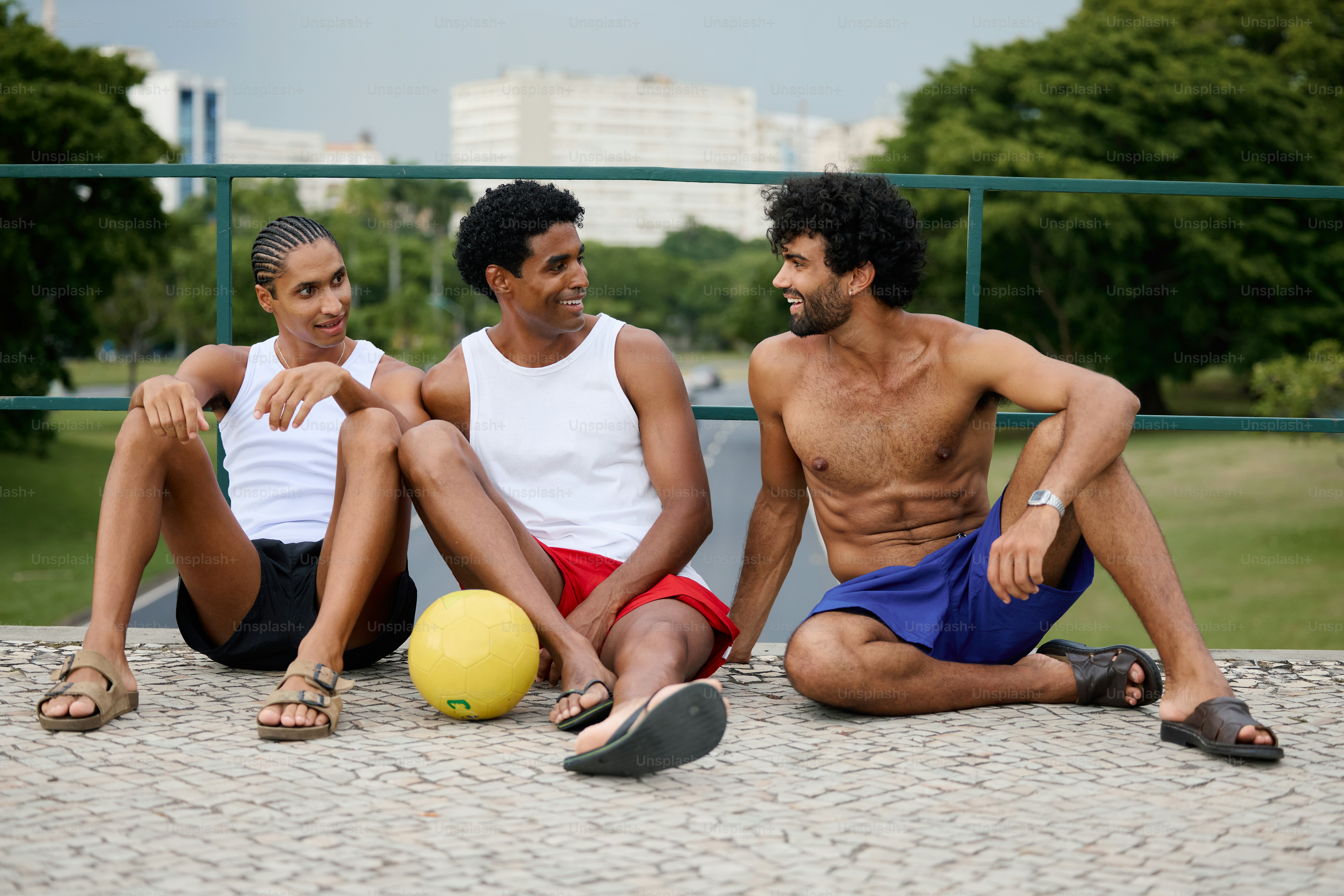 a group of three men sitting next to each other