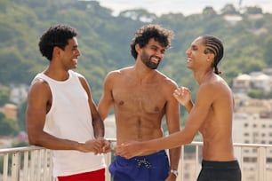 a group of three men standing next to each other