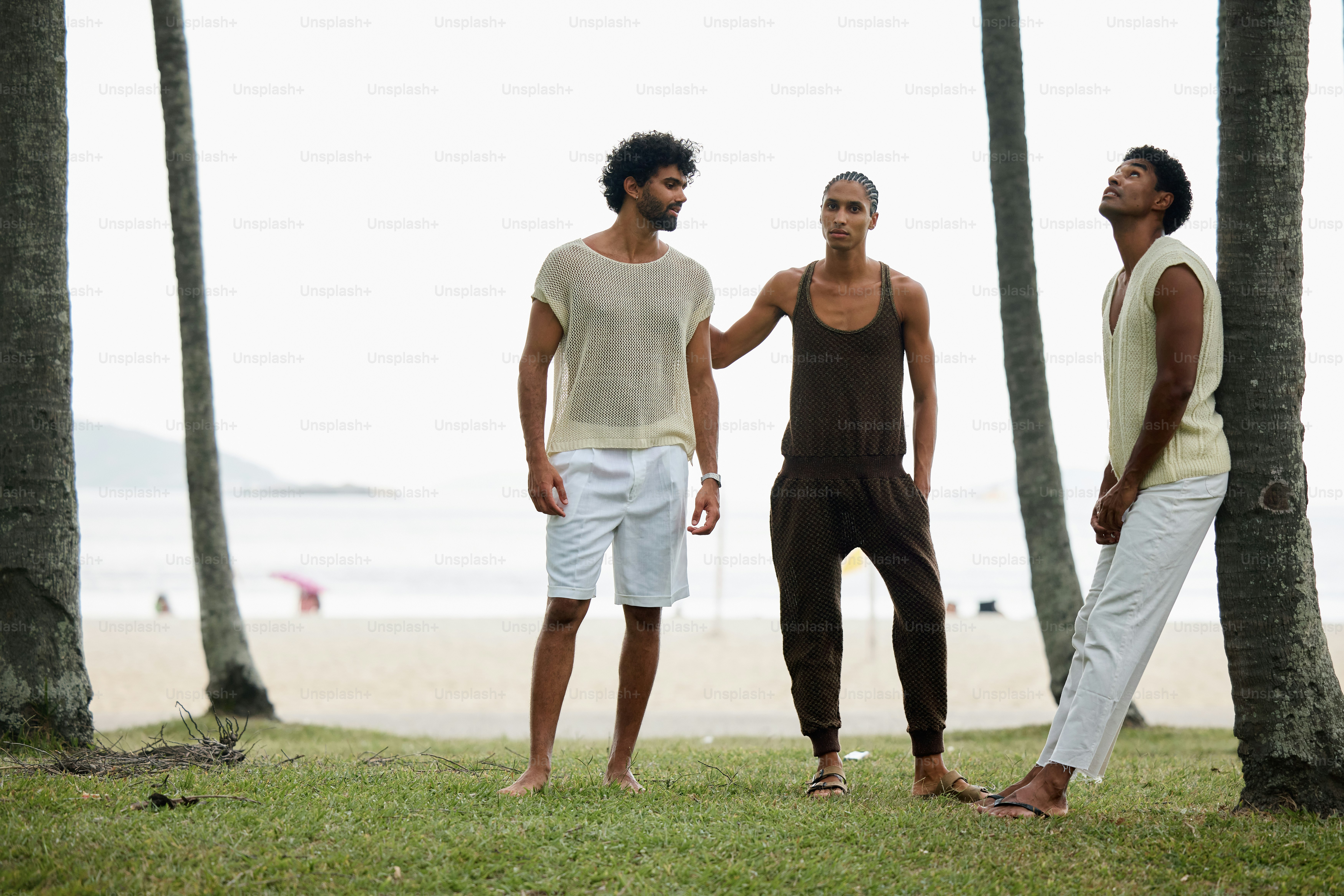 a group of three men standing next to each other