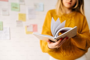 a woman holding a book in her hands