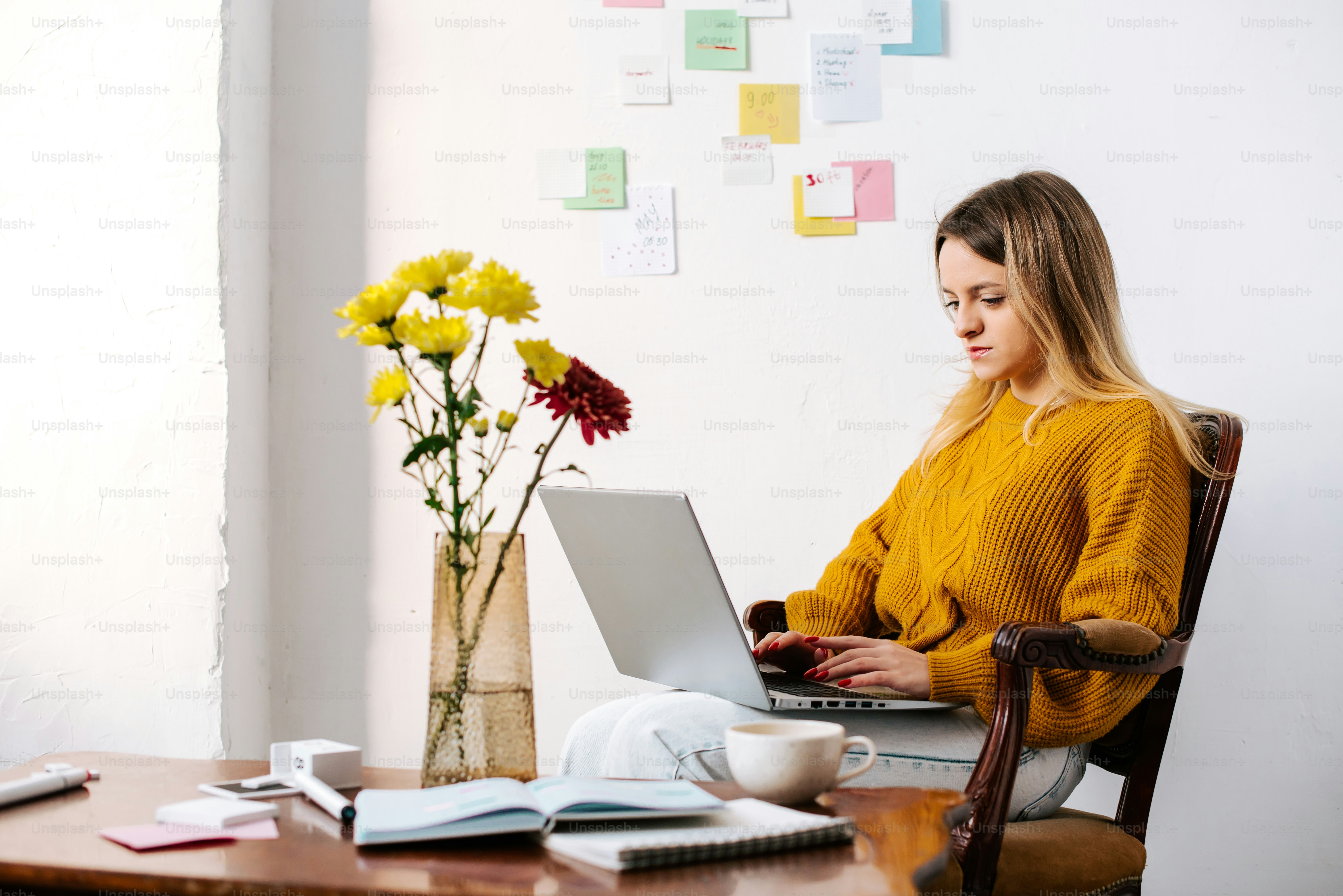 a woman sitting at a table with a laptop