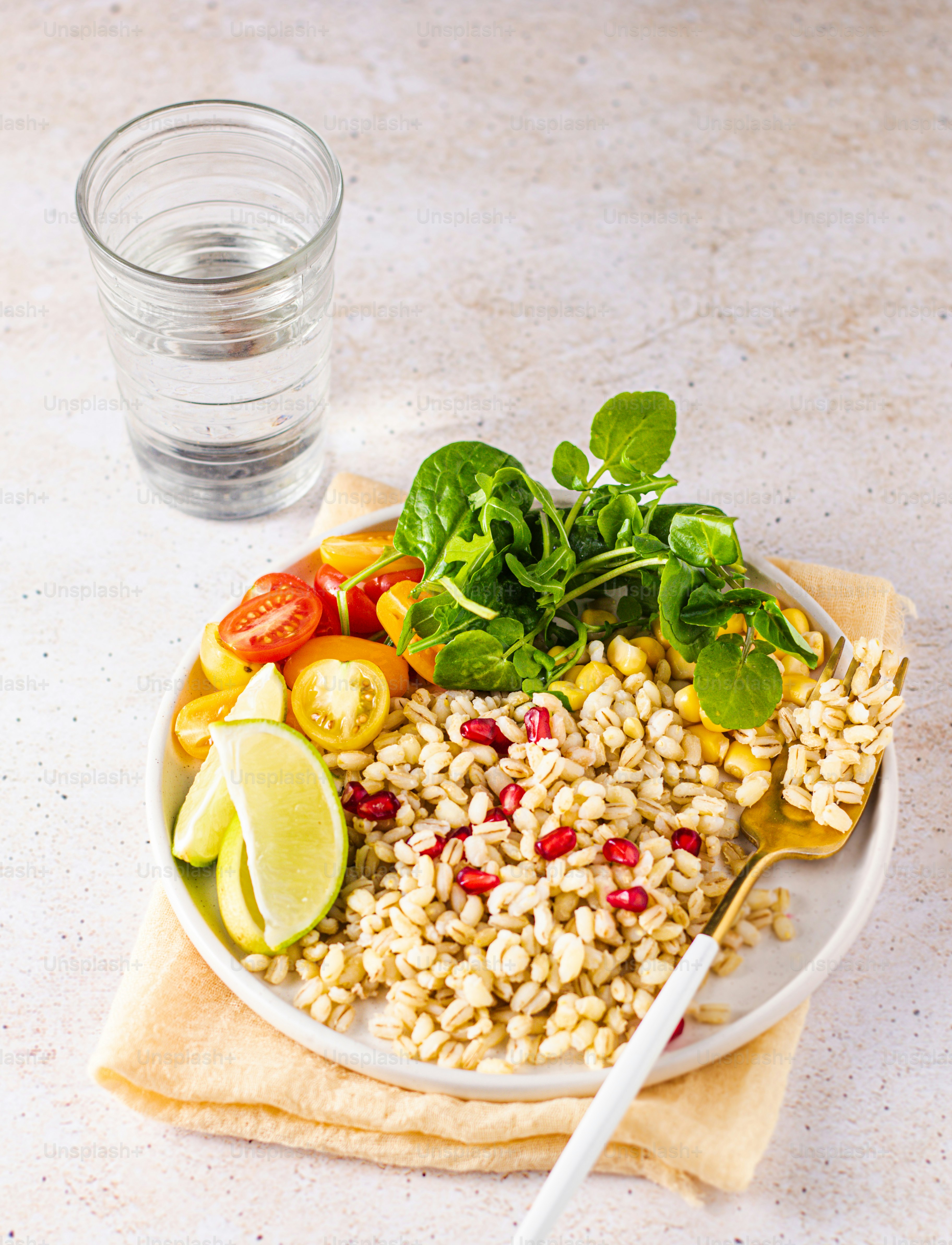 a plate of food with a fork and a glass of water