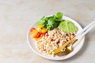 a white plate topped with a salad and a fork