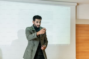 a man standing in front of a projection screen