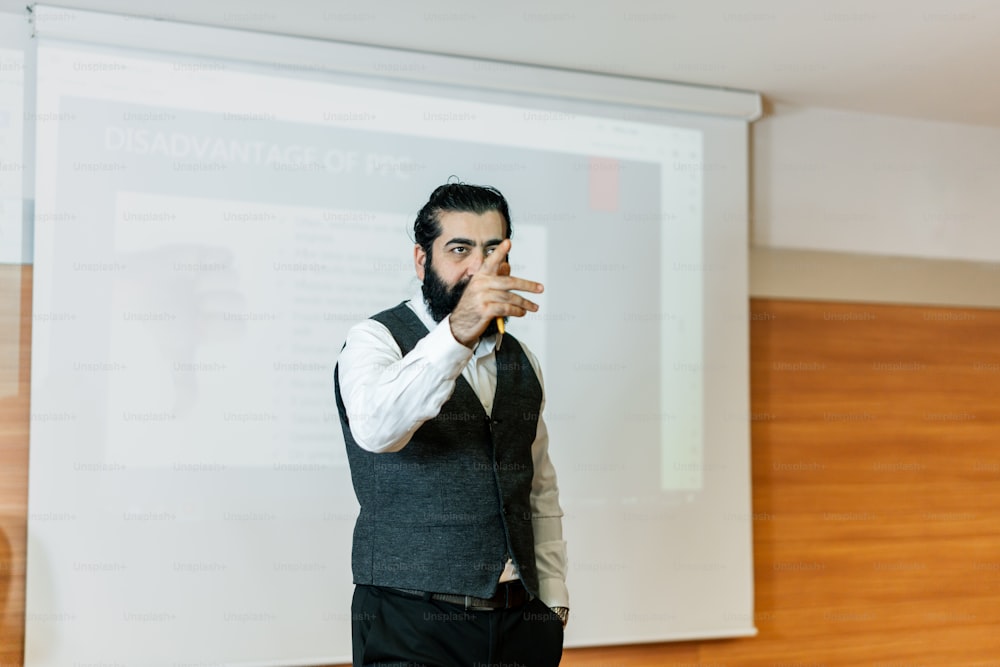 a man standing in front of a projector screen