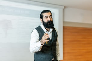 a man standing in front of a projector screen