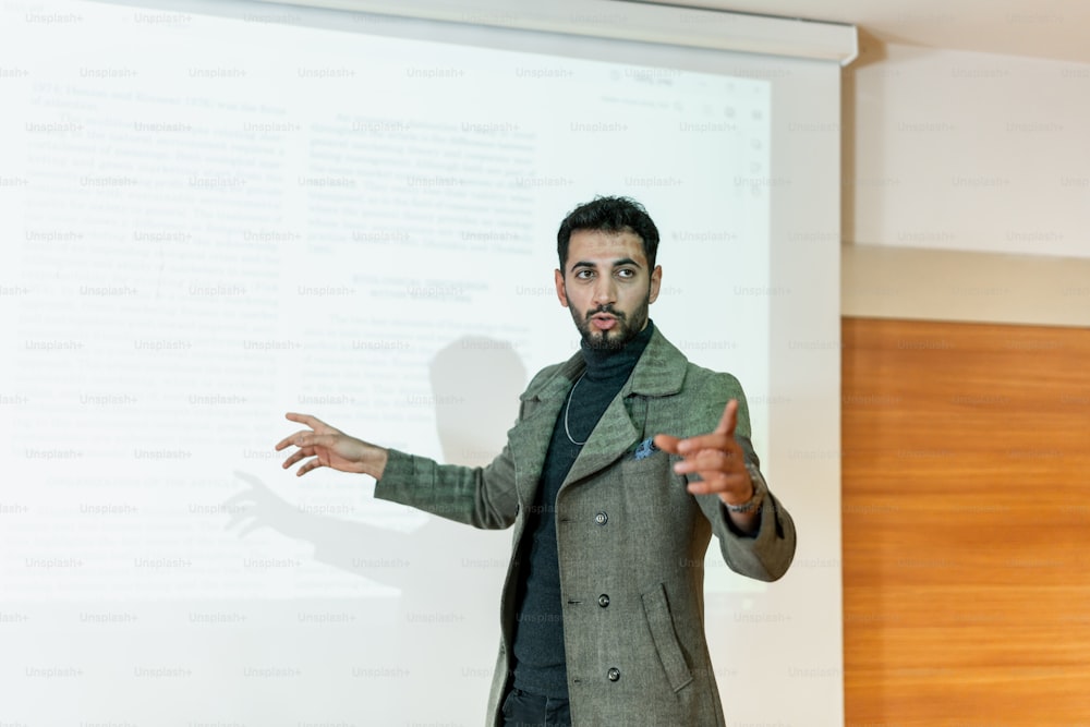 a man standing in front of a projection screen