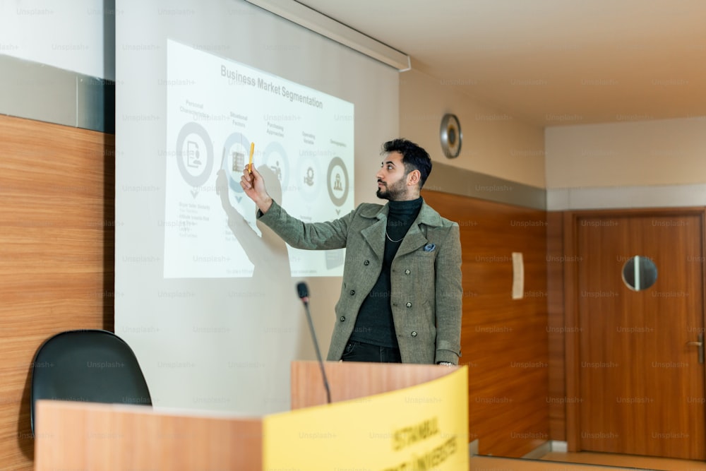 a man standing in front of a whiteboard giving a presentation