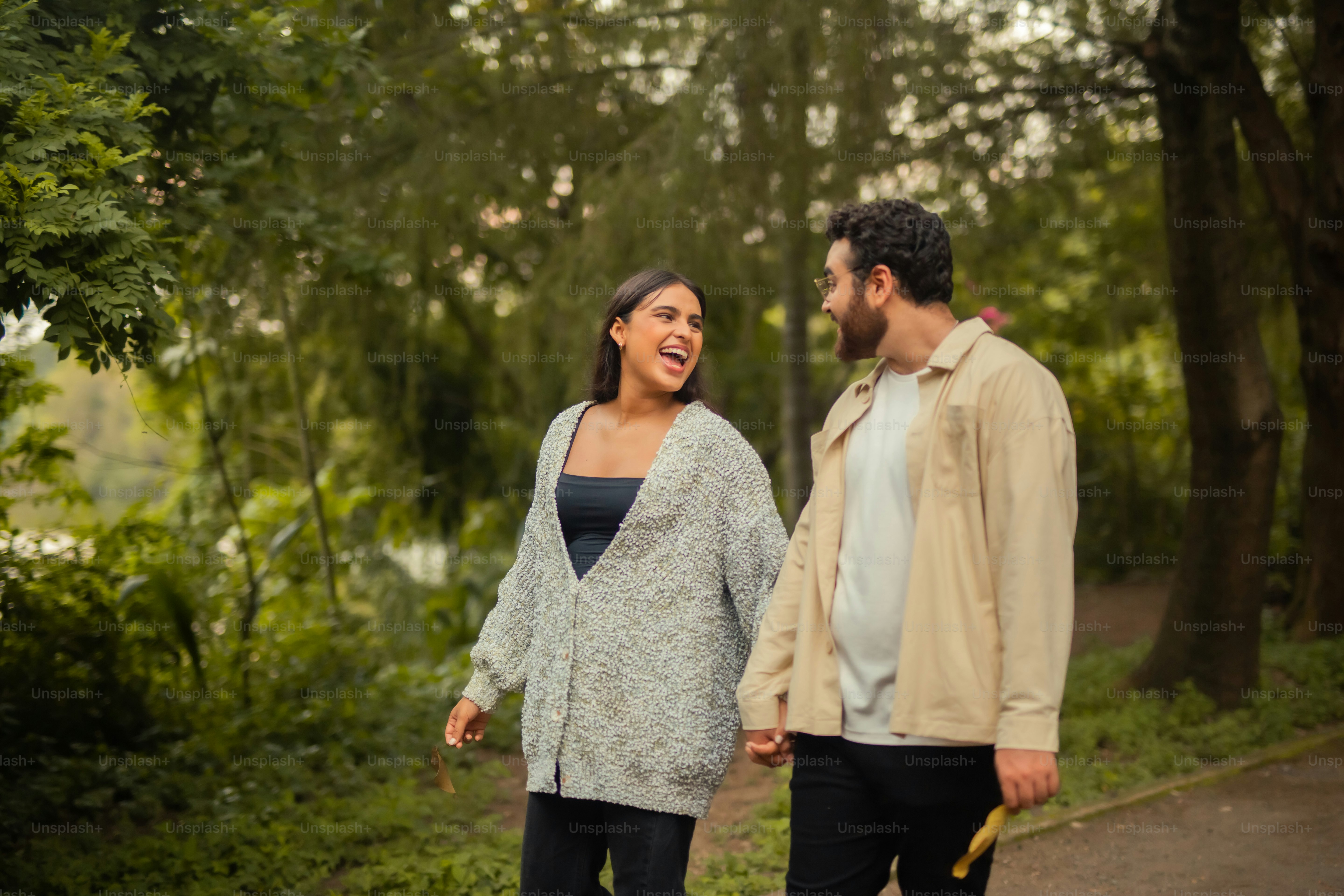 a man and a woman walking in the woods