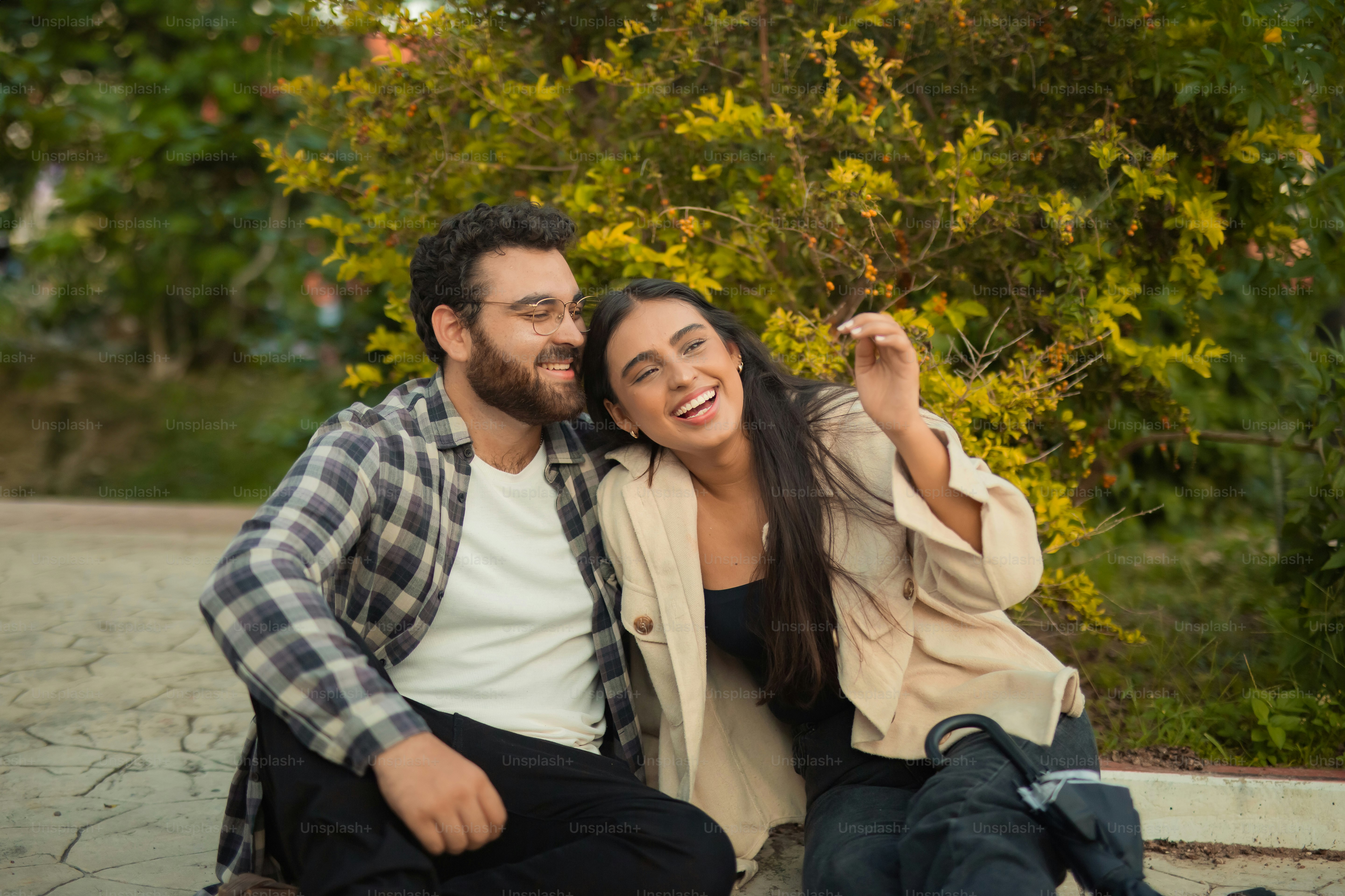 a man and a woman sitting on the ground