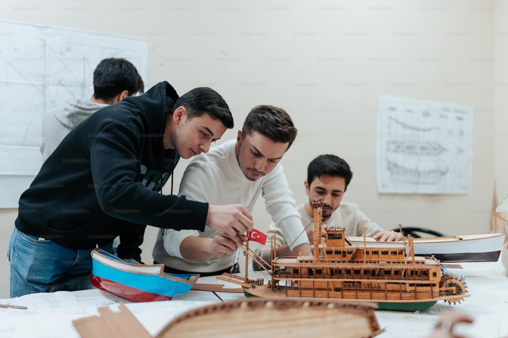a group of men working on a model of a boat