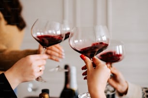 a group of people holding up wine glasses