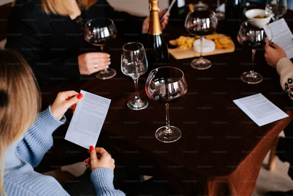 a group of people sitting around a table with wine glasses