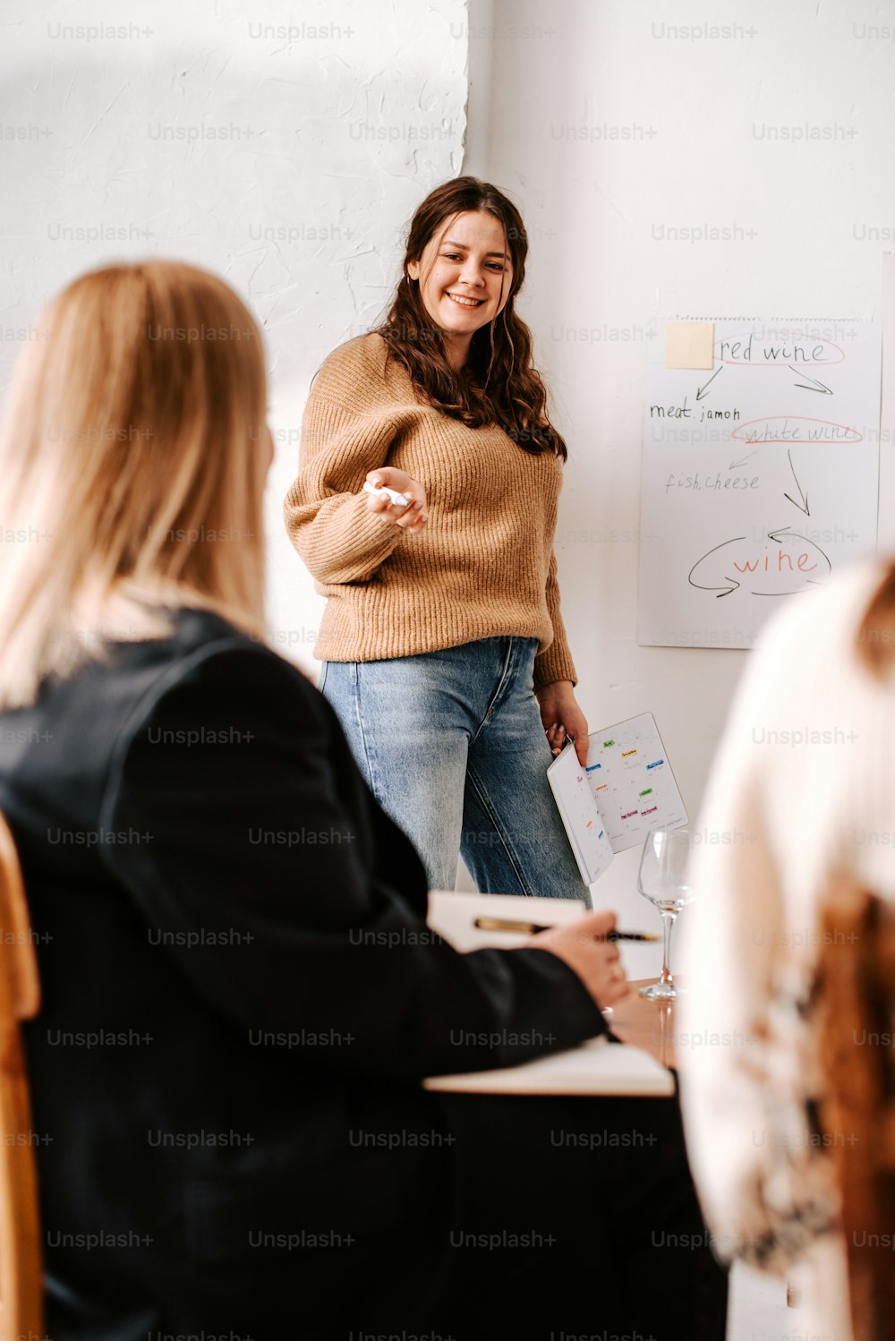 a woman standing in front of a white board