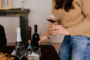 a woman is holding a glass of wine