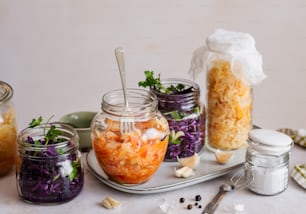 a table topped with mason jars filled with food
