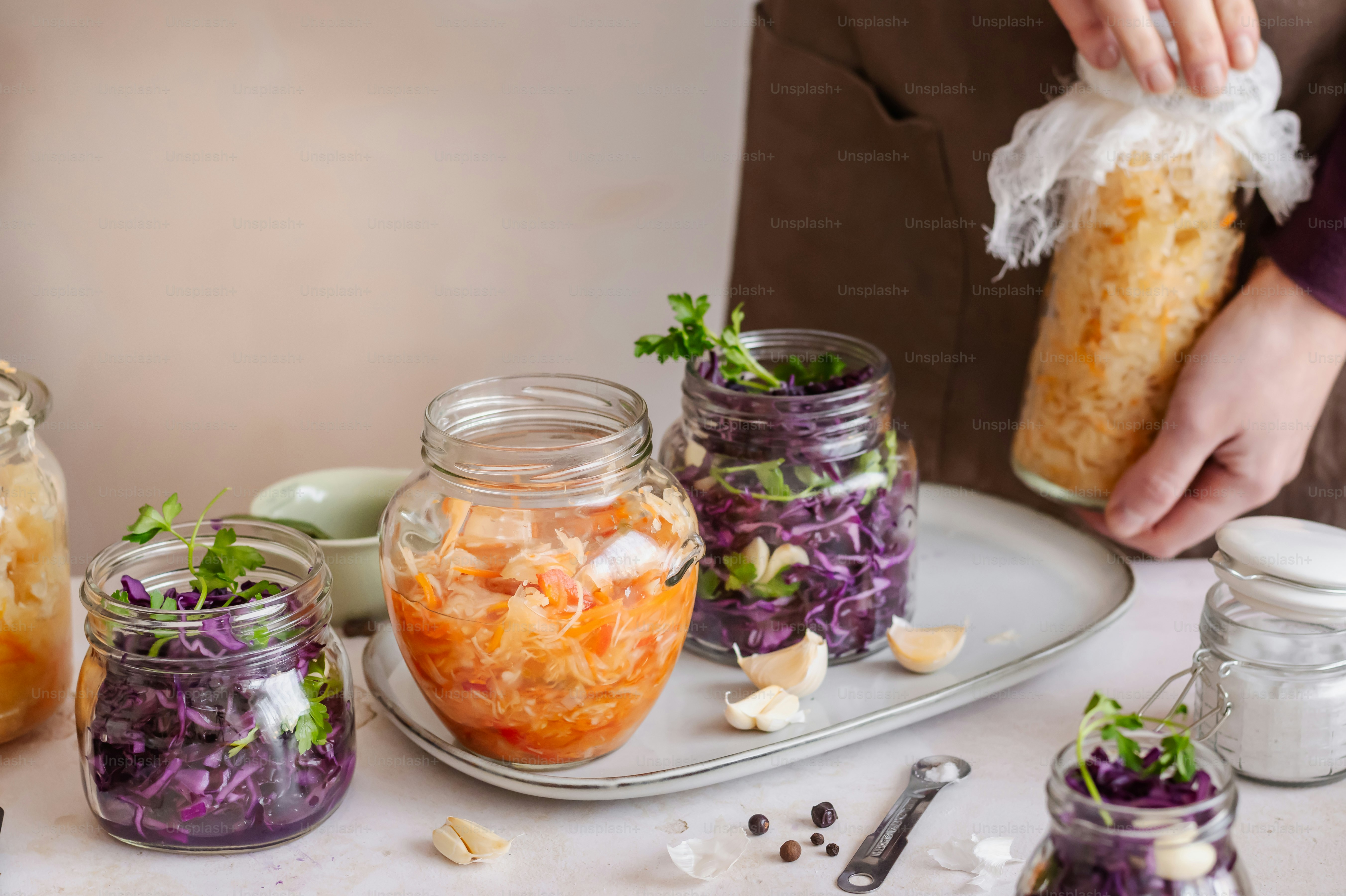 a table topped with mason jars filled with food