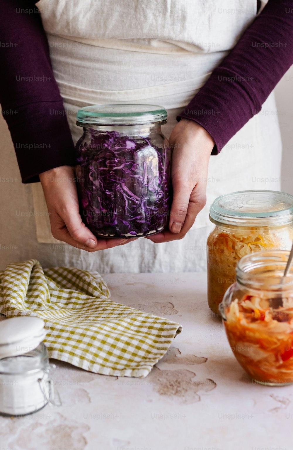 a person holding a jar of food in their hands