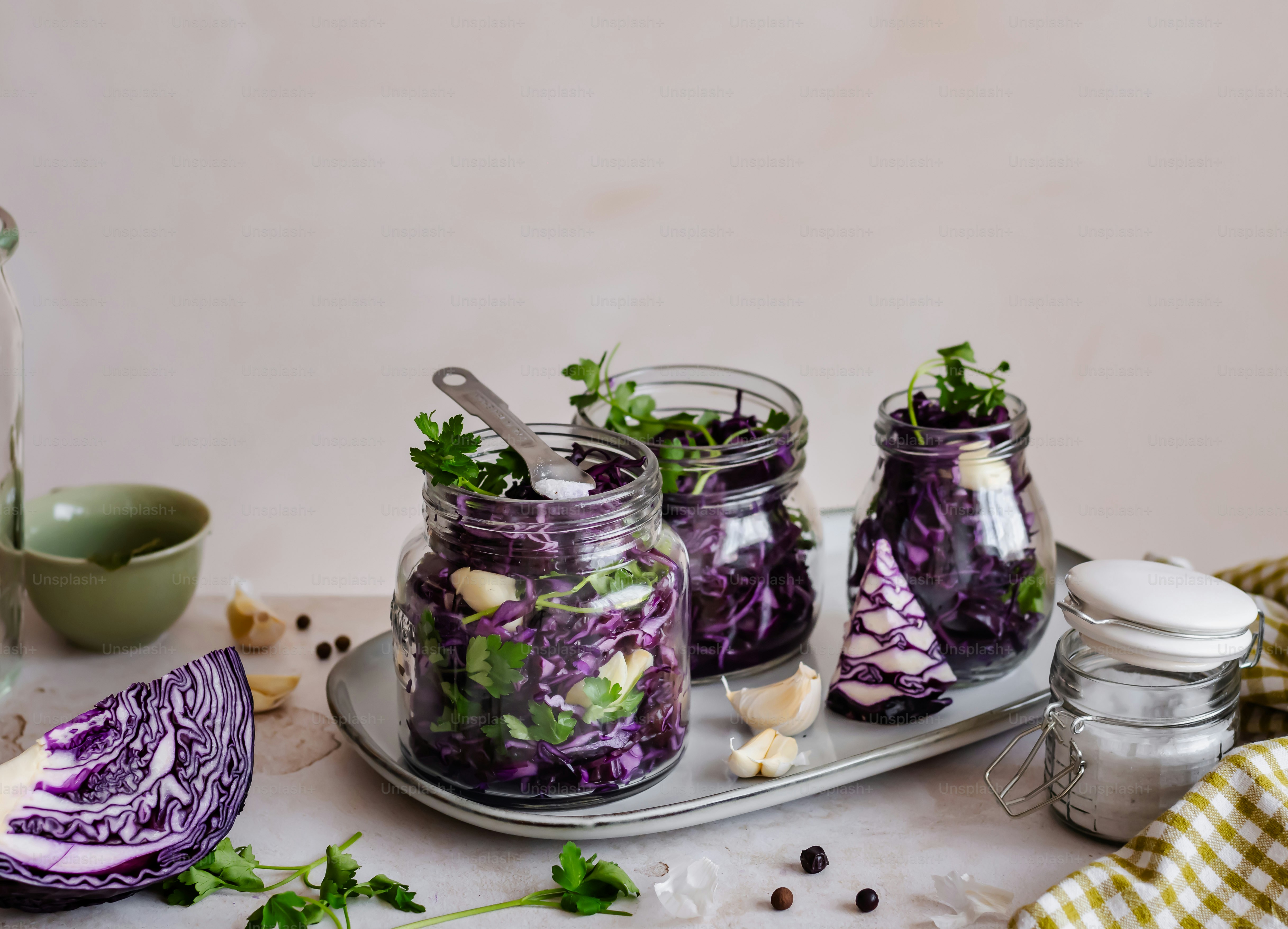a table topped with mason jars filled with food
