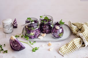 a platter with jars of purple cabbage