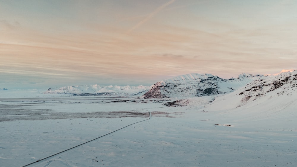 a man riding skis on top of a snow covered slope