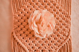 a crocheted square with a flower on top of it