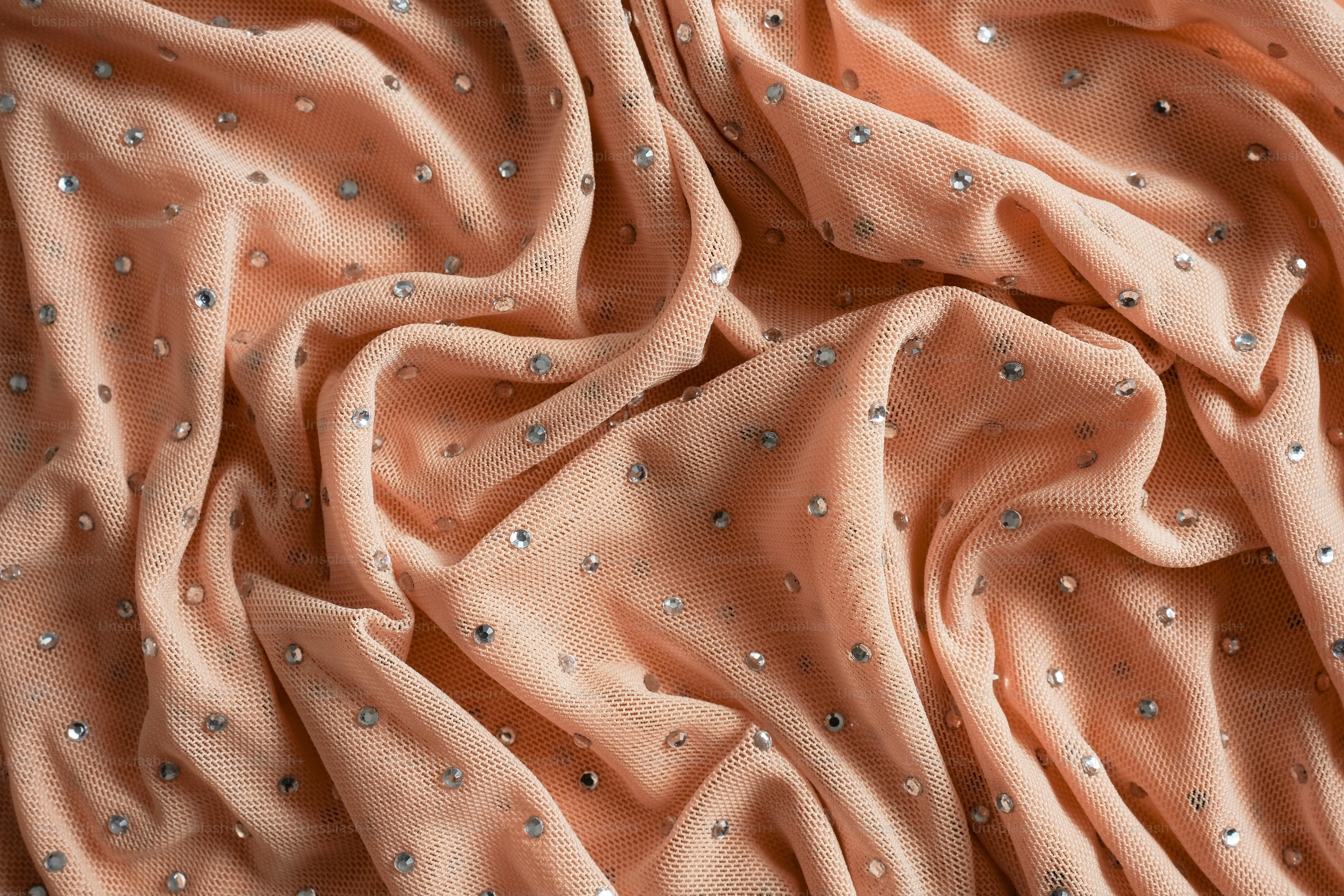 a close up view of a pink fabric with silver sequins