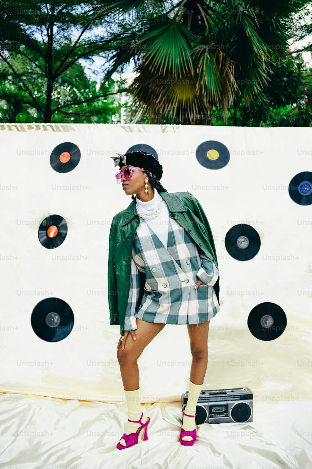 a woman standing in front of a wall with records on it