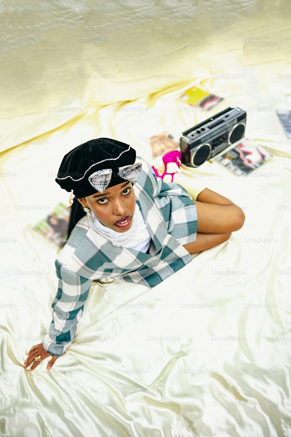 a woman laying on a bed with a hat on her head