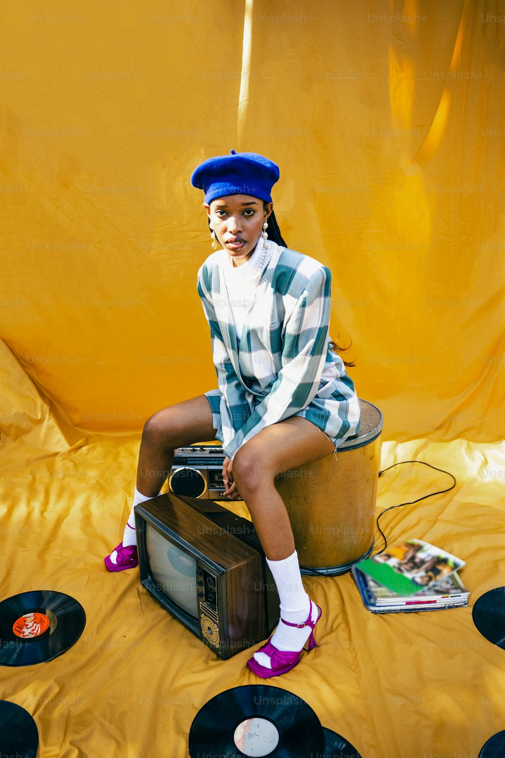 a woman sitting on top of a record player
