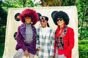 a group of three women standing next to each other