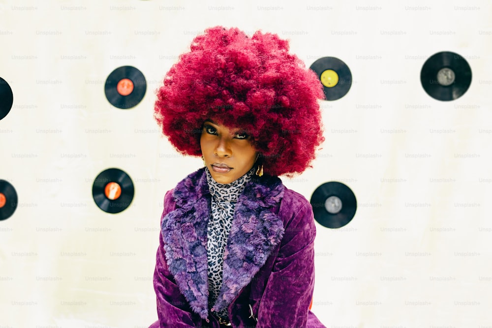 a woman with red hair and a purple jacket