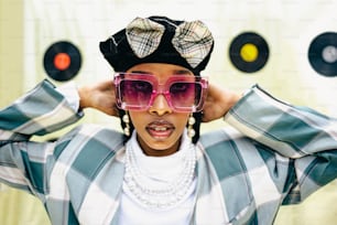 a woman wearing a hat, sunglasses and a bow tie