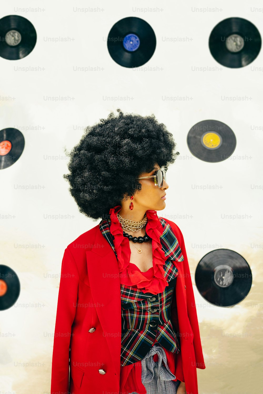 a woman wearing a red jacket and sunglasses