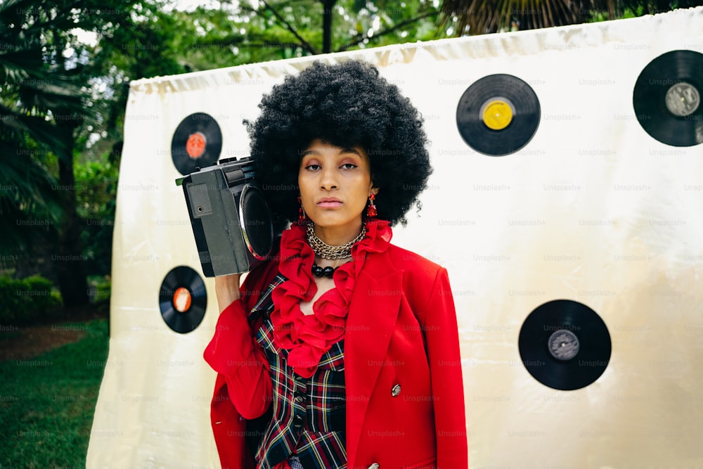 a woman with an afro holding a record player