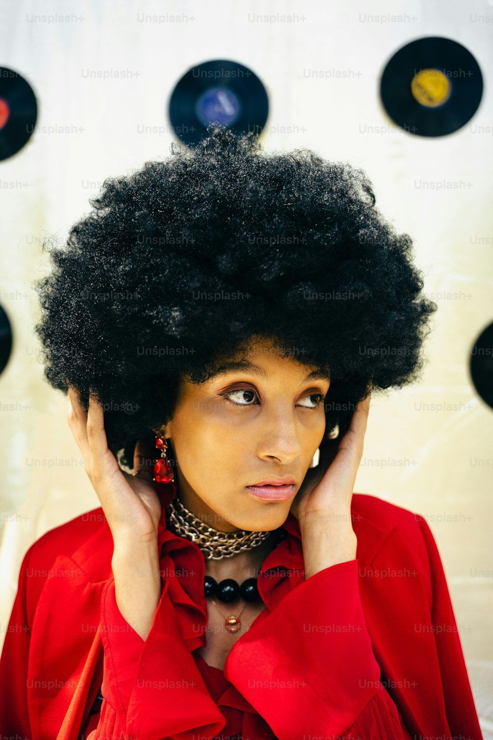 a woman with an afro is holding her head