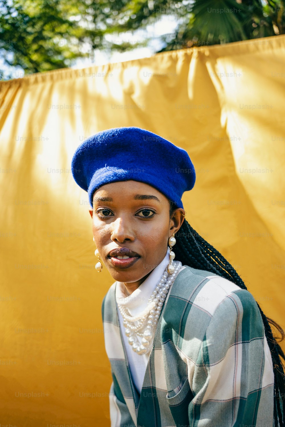 a woman wearing a blue hat and a green and white shirt