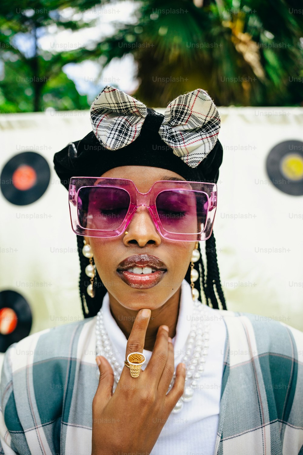 a woman wearing pink sunglasses and a bow tie