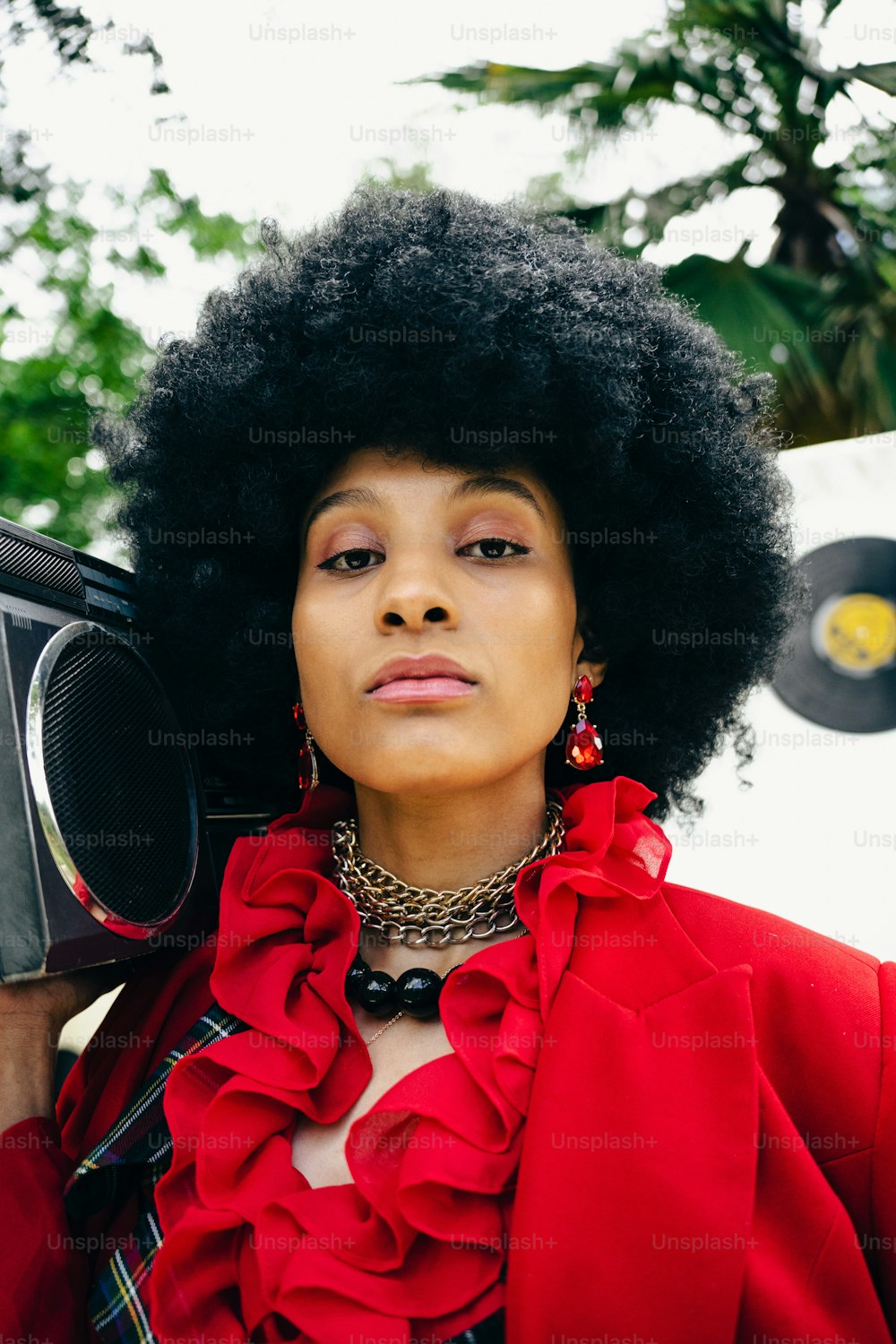 a woman with an afro holding a boombox